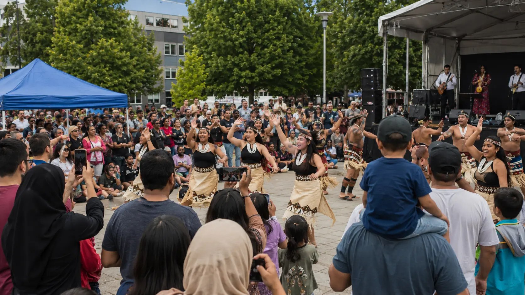 Pacific Islander dance group mid-performance in front of an outdoor stage